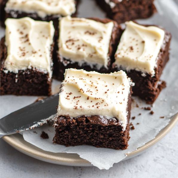 A plate with brownies with cream cheese frosting, ready to enjoy in family, recipe by Goya Recipes.